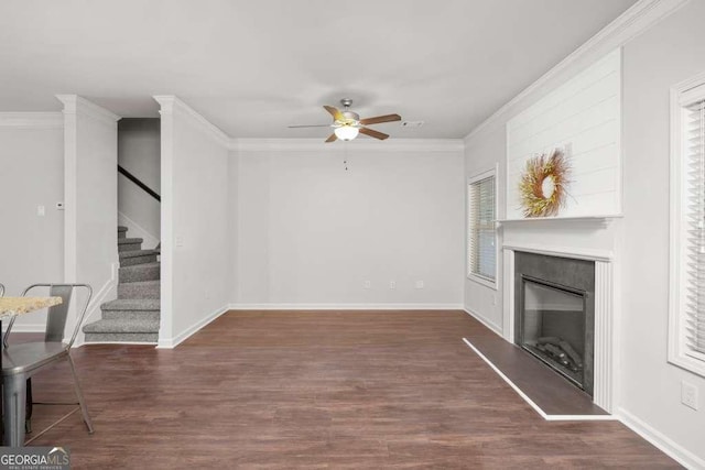 unfurnished living room with crown molding, dark wood-type flooring, and ceiling fan