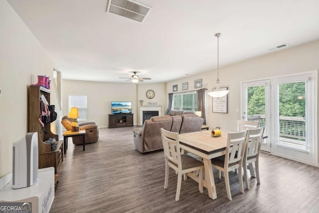 dining area with dark wood-type flooring and ceiling fan