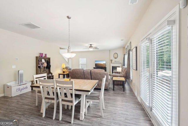 dining space with wood-type flooring and ceiling fan