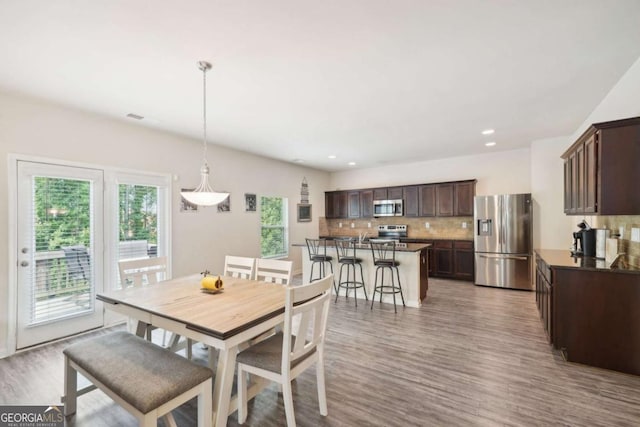 dining space with light hardwood / wood-style floors