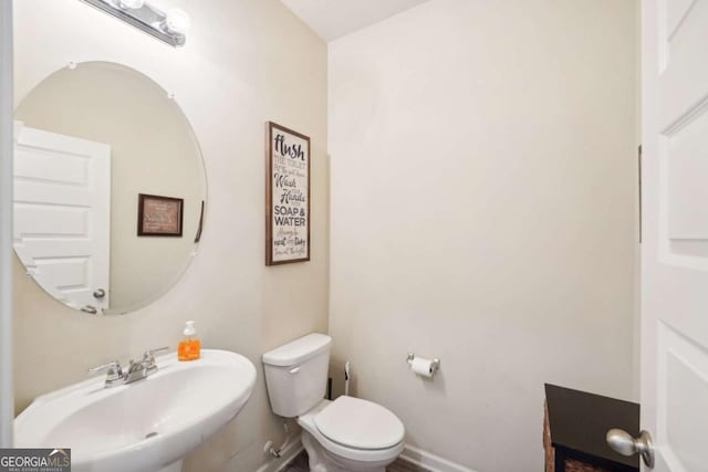 bathroom featuring sink and toilet