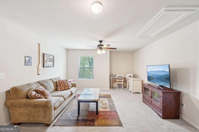 carpeted living room with ceiling fan