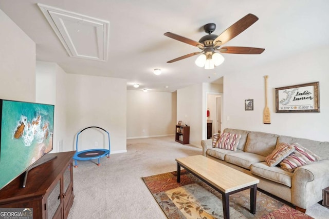 carpeted living room with ceiling fan