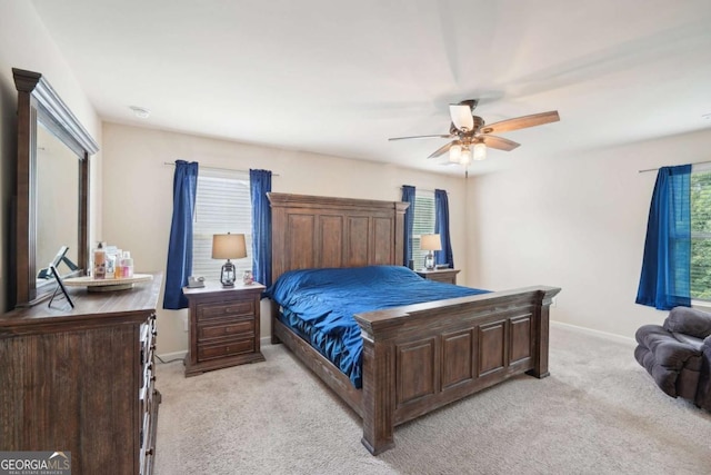 bedroom featuring light colored carpet and ceiling fan