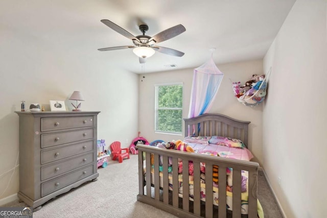 bedroom with ceiling fan and light carpet