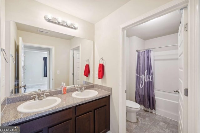 full bathroom with vanity, shower / bathtub combination with curtain, and toilet