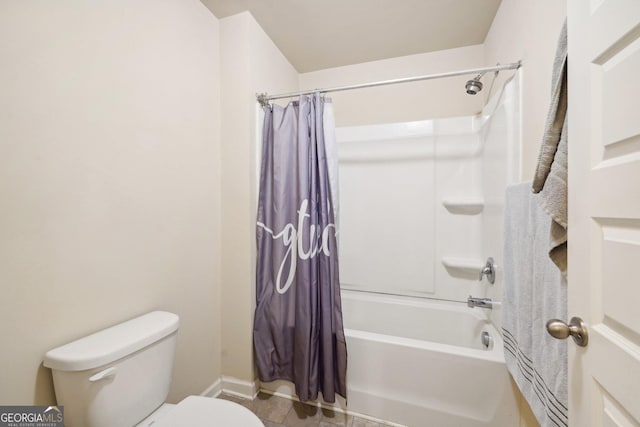 bathroom with shower / bath combo and toilet