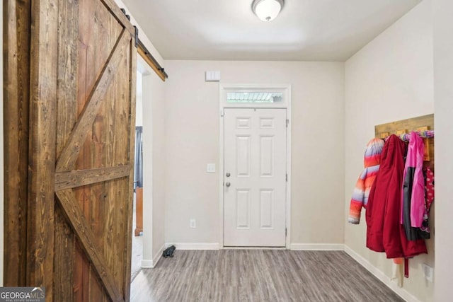 entryway with hardwood / wood-style flooring and a barn door