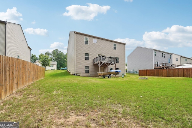 rear view of property with a yard