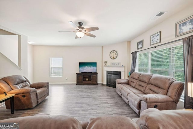 living room featuring wood-type flooring and ceiling fan