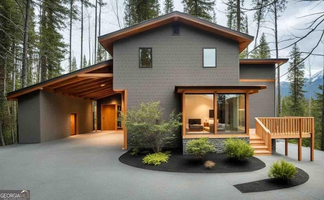 exterior space with a carport and a wooden deck