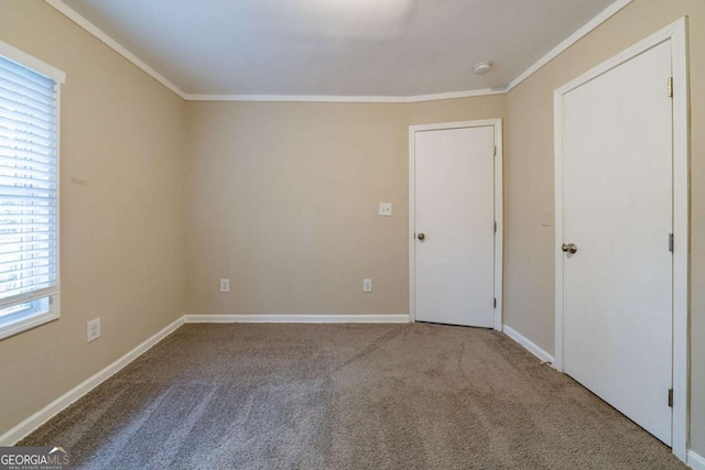 carpeted empty room with crown molding