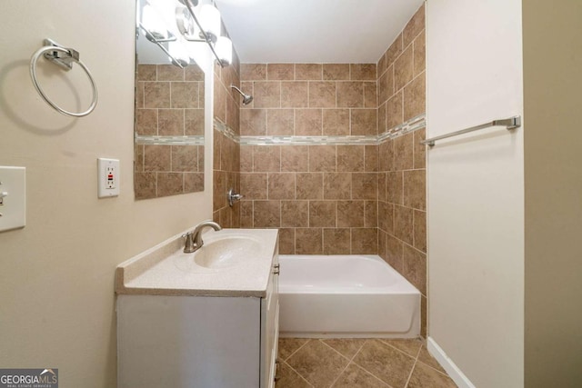 bathroom with tile patterned flooring, vanity, and tiled shower / bath