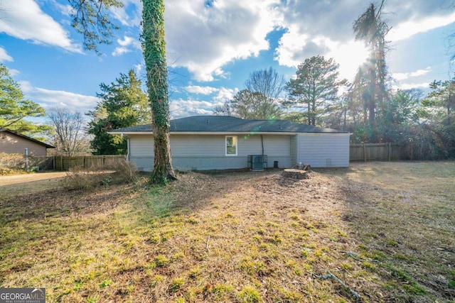 exterior space with central AC and a lawn