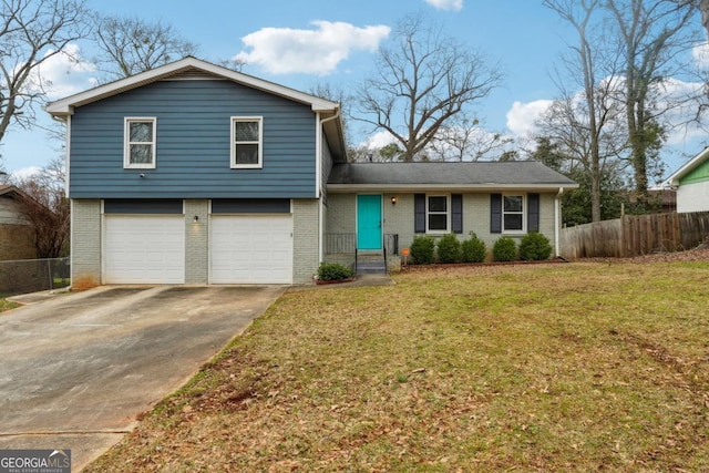 split level home featuring a garage and a front lawn