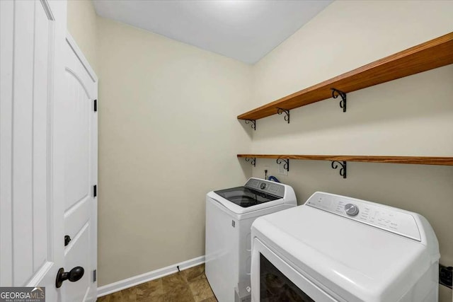 clothes washing area with washer and clothes dryer