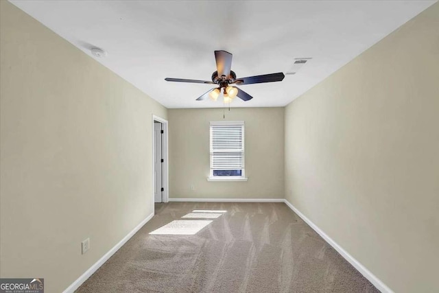 carpeted spare room featuring ceiling fan