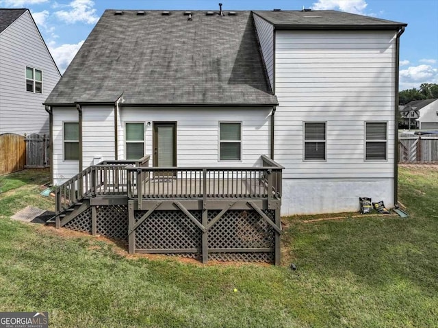 back of house with a wooden deck and a yard