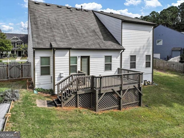 back of property featuring a yard and a deck