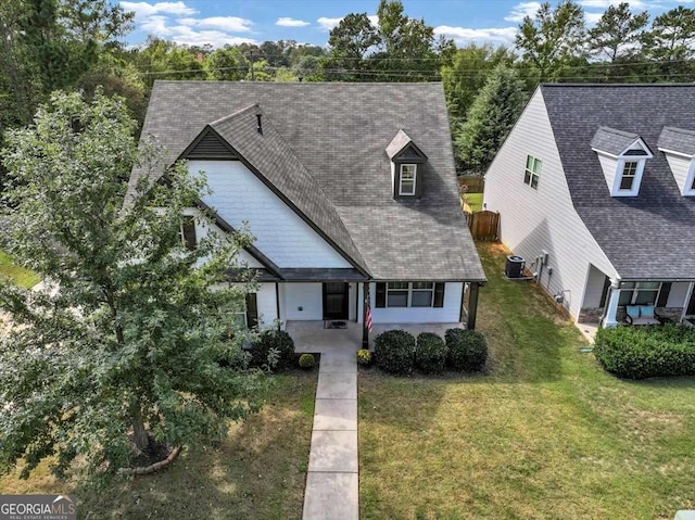 view of front of home featuring a front yard and central AC unit