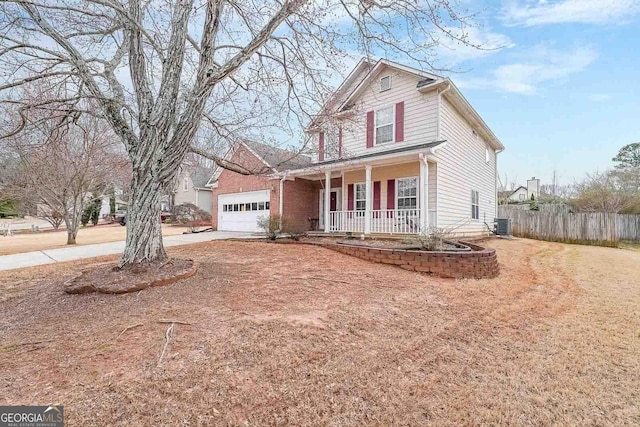 front of property with a porch, a garage, and central air condition unit