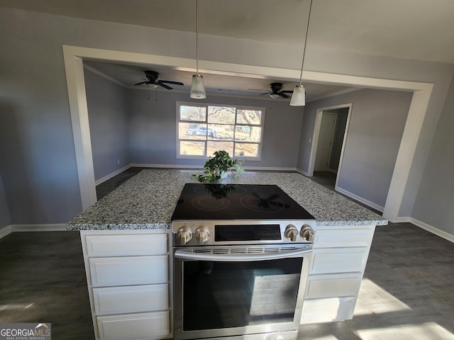 kitchen featuring pendant lighting, white cabinetry, light stone countertops, and stainless steel range with electric cooktop