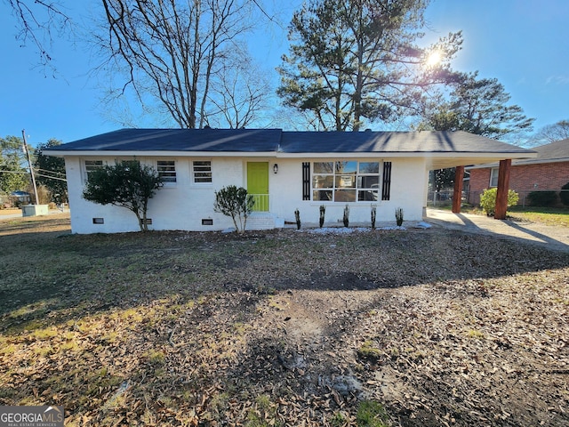 single story home featuring a carport