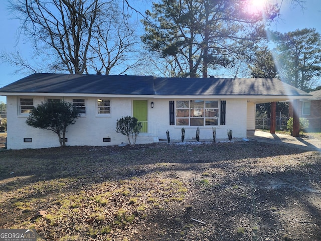 ranch-style home with a carport