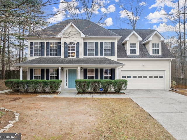 colonial inspired home featuring a porch and a garage