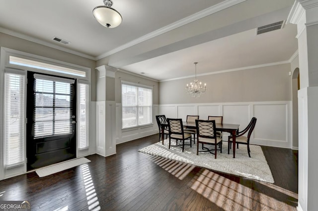 dining area with ornamental molding, dark hardwood / wood-style flooring, and a notable chandelier