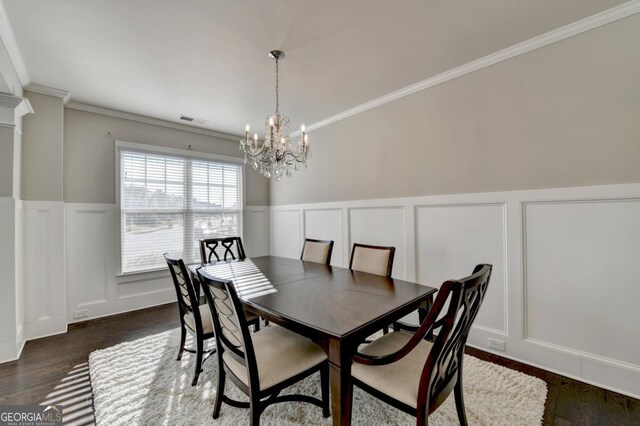 dining room with crown molding and dark wood-type flooring