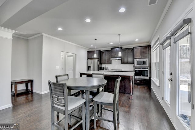 dining area with crown molding and dark hardwood / wood-style floors