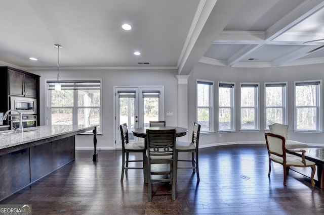 dining room with ornamental molding, sink, and dark hardwood / wood-style flooring