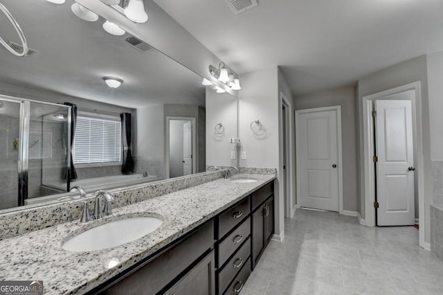 bathroom featuring vanity, independent shower and bath, and tile patterned flooring