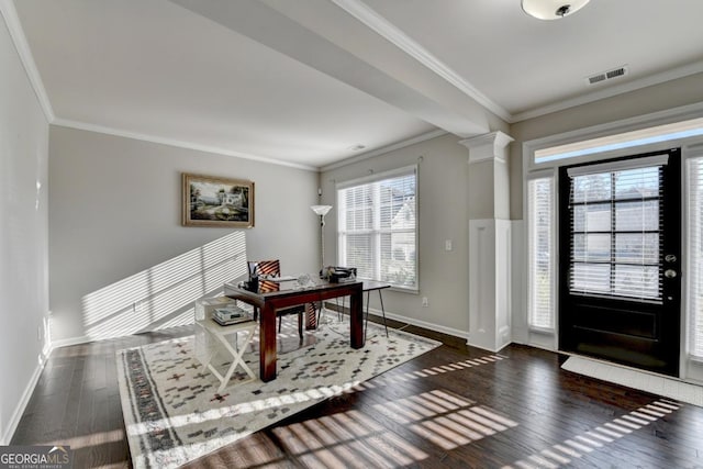 entryway featuring crown molding, dark hardwood / wood-style floors, and ornate columns