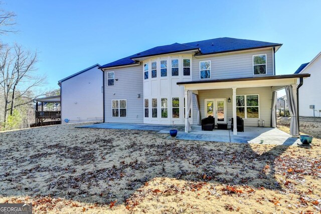 back of house featuring a patio area and french doors