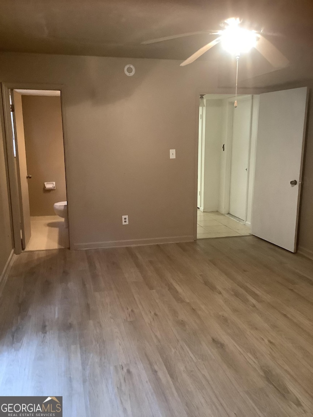 interior space featuring ensuite bath and light wood-type flooring