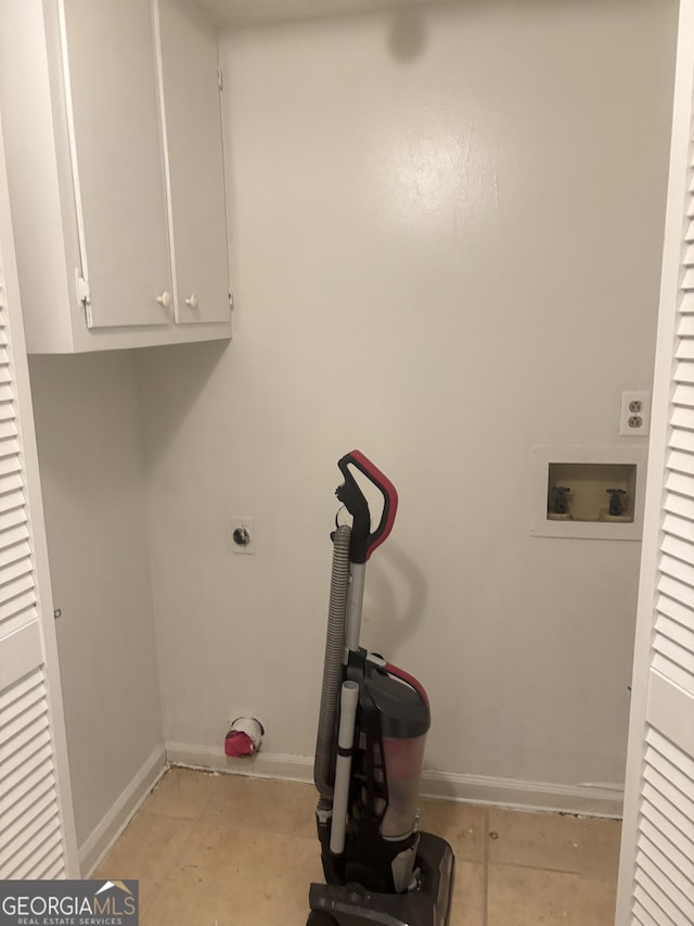 clothes washing area featuring cabinets, electric dryer hookup, and washer hookup