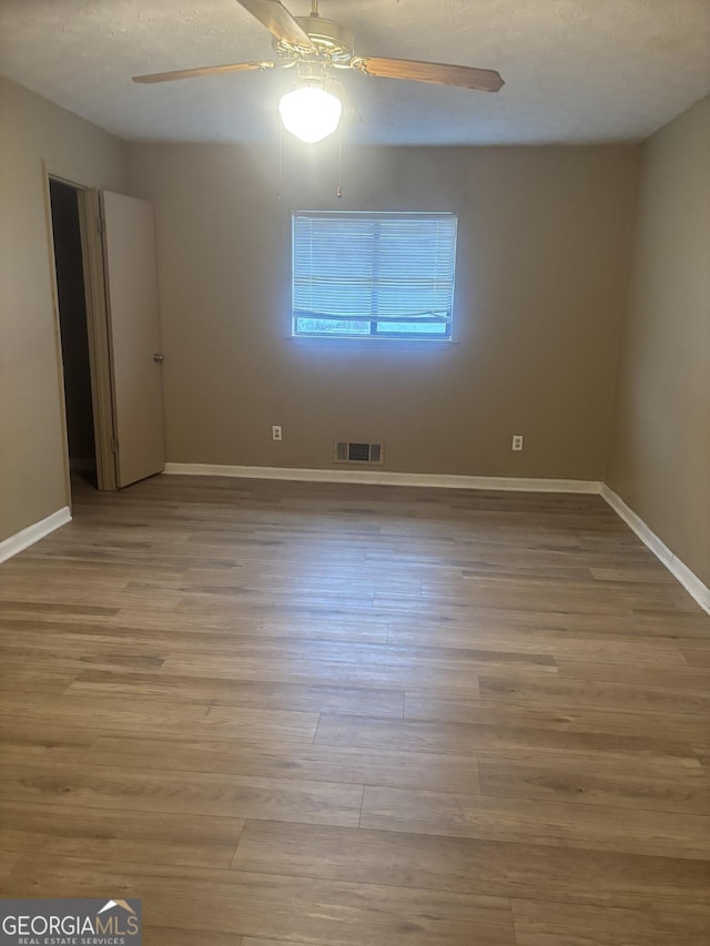 unfurnished room with light hardwood / wood-style floors and ceiling fan