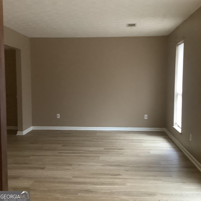 spare room featuring light hardwood / wood-style flooring