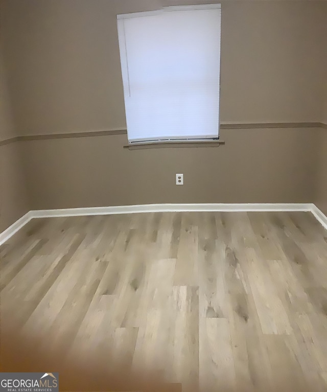 unfurnished room with light hardwood / wood-style flooring