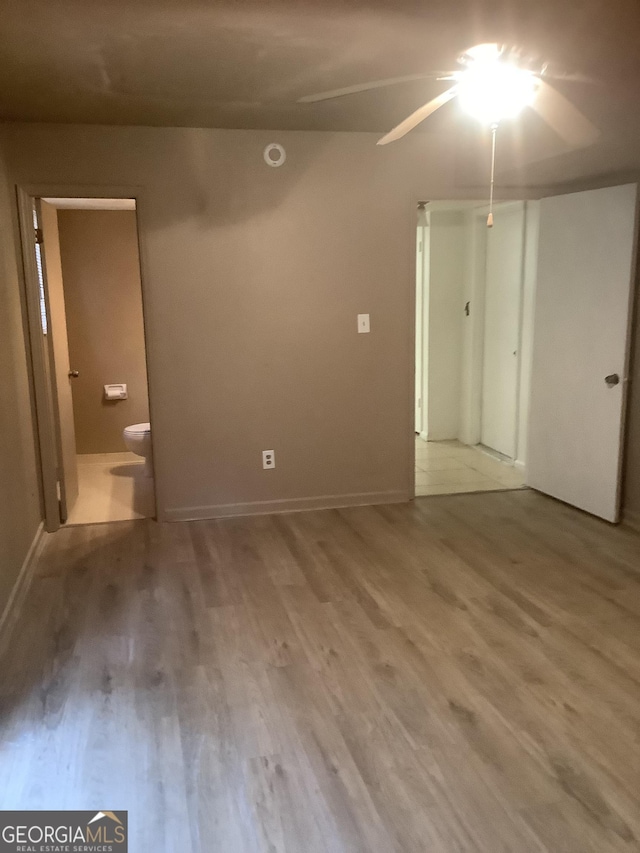 unfurnished room with hardwood / wood-style flooring and ceiling fan