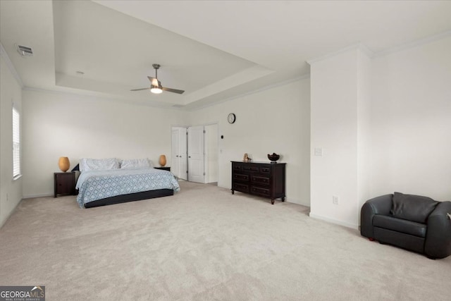 bedroom featuring light carpet, crown molding, and a raised ceiling