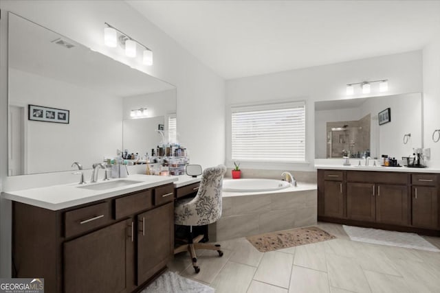 bathroom with vanity and independent shower and bath