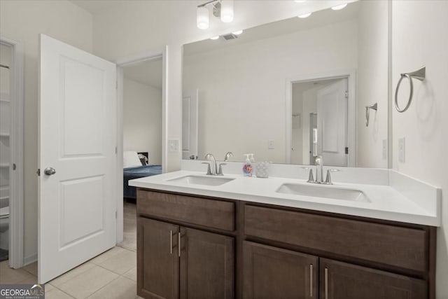 bathroom with vanity, tile patterned floors, and toilet