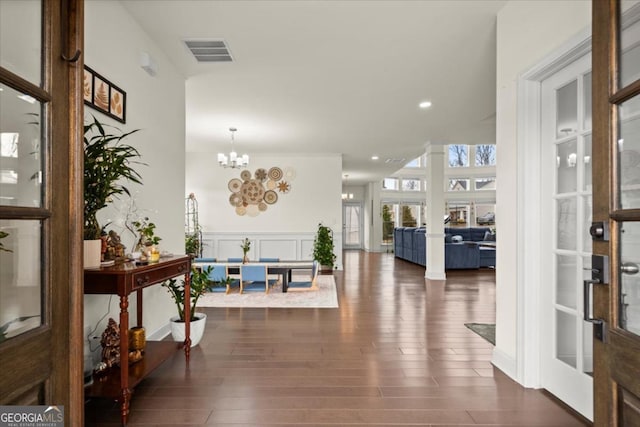 entrance foyer featuring dark wood-type flooring and a chandelier