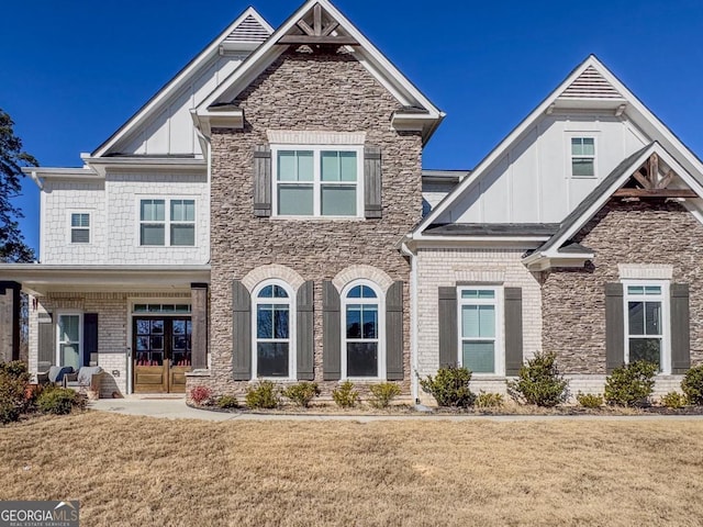 craftsman house with a front yard and french doors