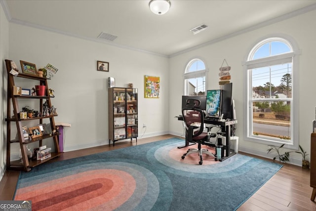 home office with wood-type flooring and ornamental molding