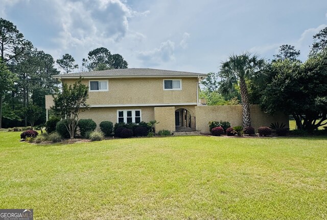 123 Blount St, Reidsville, GA 30453 - colonial house with a front yard and stucco siding