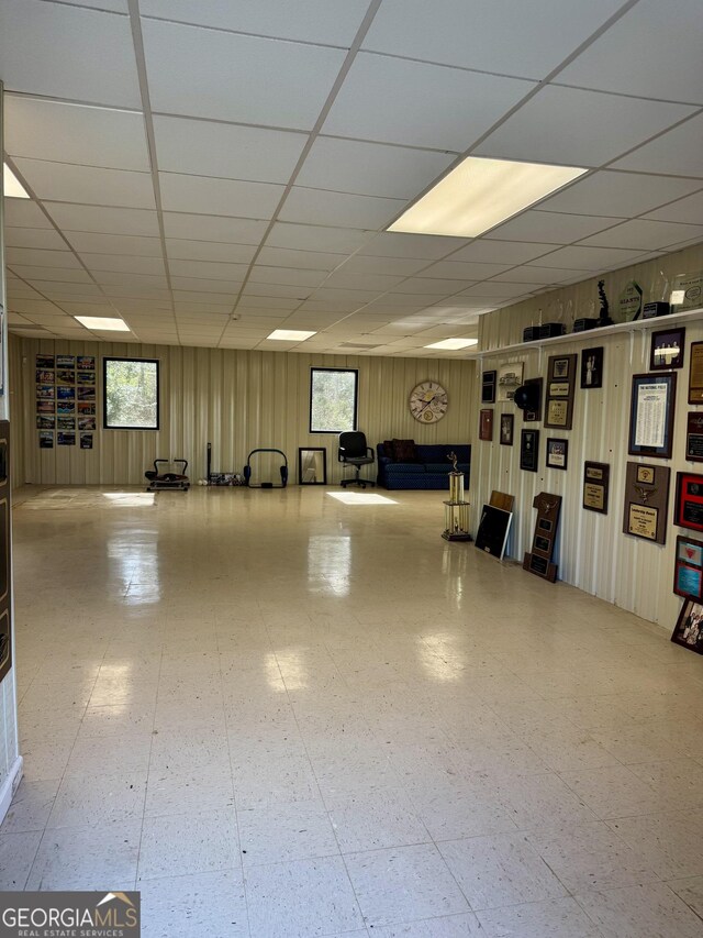 123 Blount St, Reidsville, GA 30453 - below grade area with tile patterned floors, wood walls, and a drop ceiling